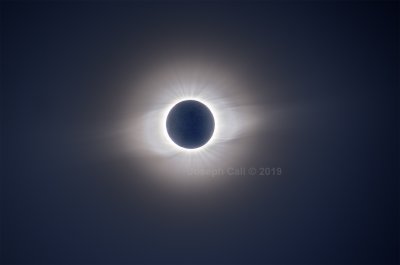 A single telephoto image of a total solar eclipse showing the corona streaming out from behind the Moon. The image has been made by combining 12 individual images.
